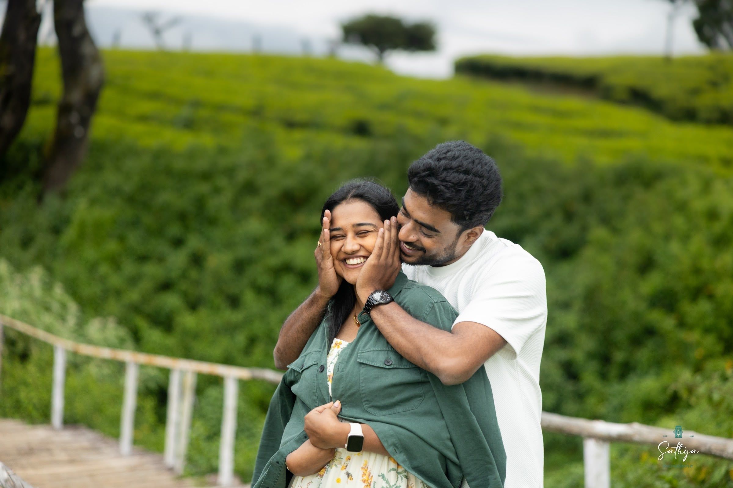 Bride laughing in her partner’s arms in a tea garden