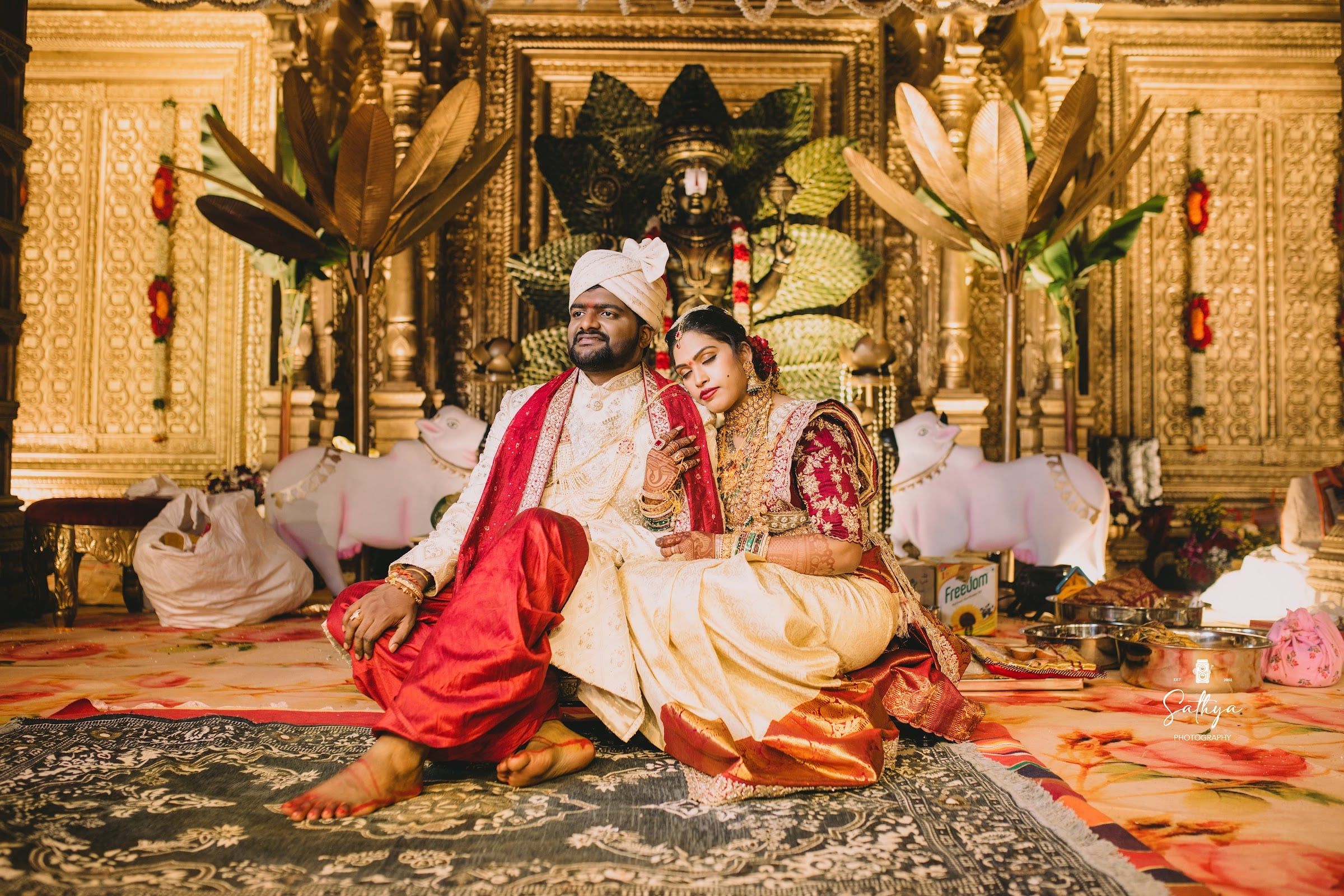 Bride and groom resting together on the mandap after the rituals