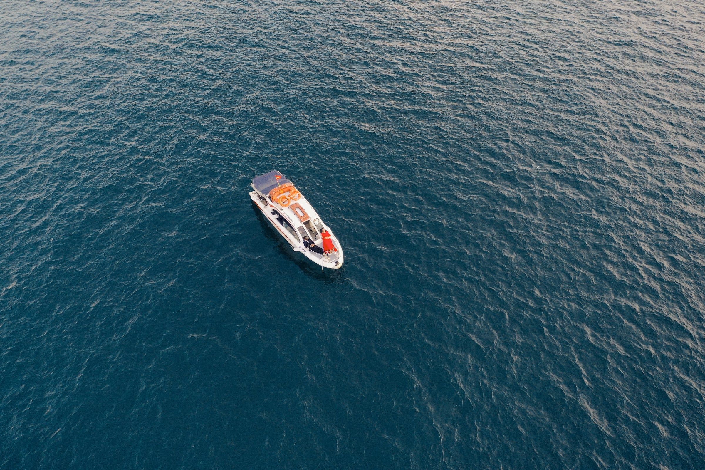 Aerial view of a yacht on deep blue water